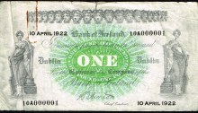 1922 Bank of Ireland One Pound, 10 April 1922, serial number 10A000001. Signed S. Hinton. Tear at top centre, rustmarks from paper clip, about very fine